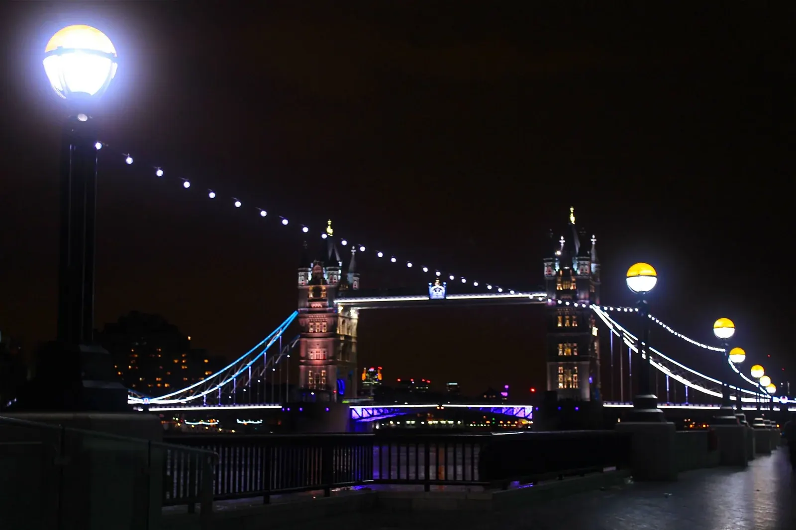 Tower Bridge illuminated at night across the Thames